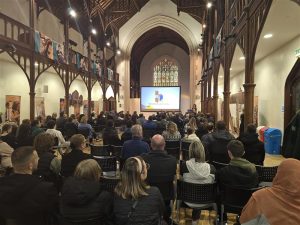 The Great Hall filled with parents and carers listening to a talk about Highlands College